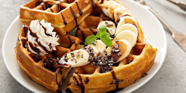 Breakfast waffles with bananas and chocolate sauce