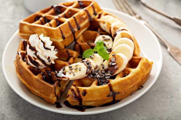 Breakfast waffles with bananas and chocolate sauce