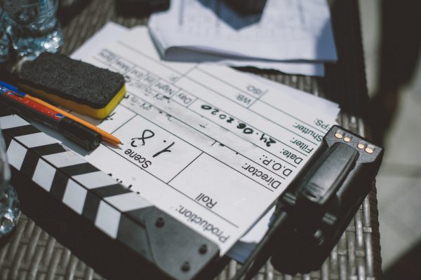 Assistant director with clapperboard on set. Close-up of firecrackers for filming a movie, advertising, TV series. Modern photography technique.